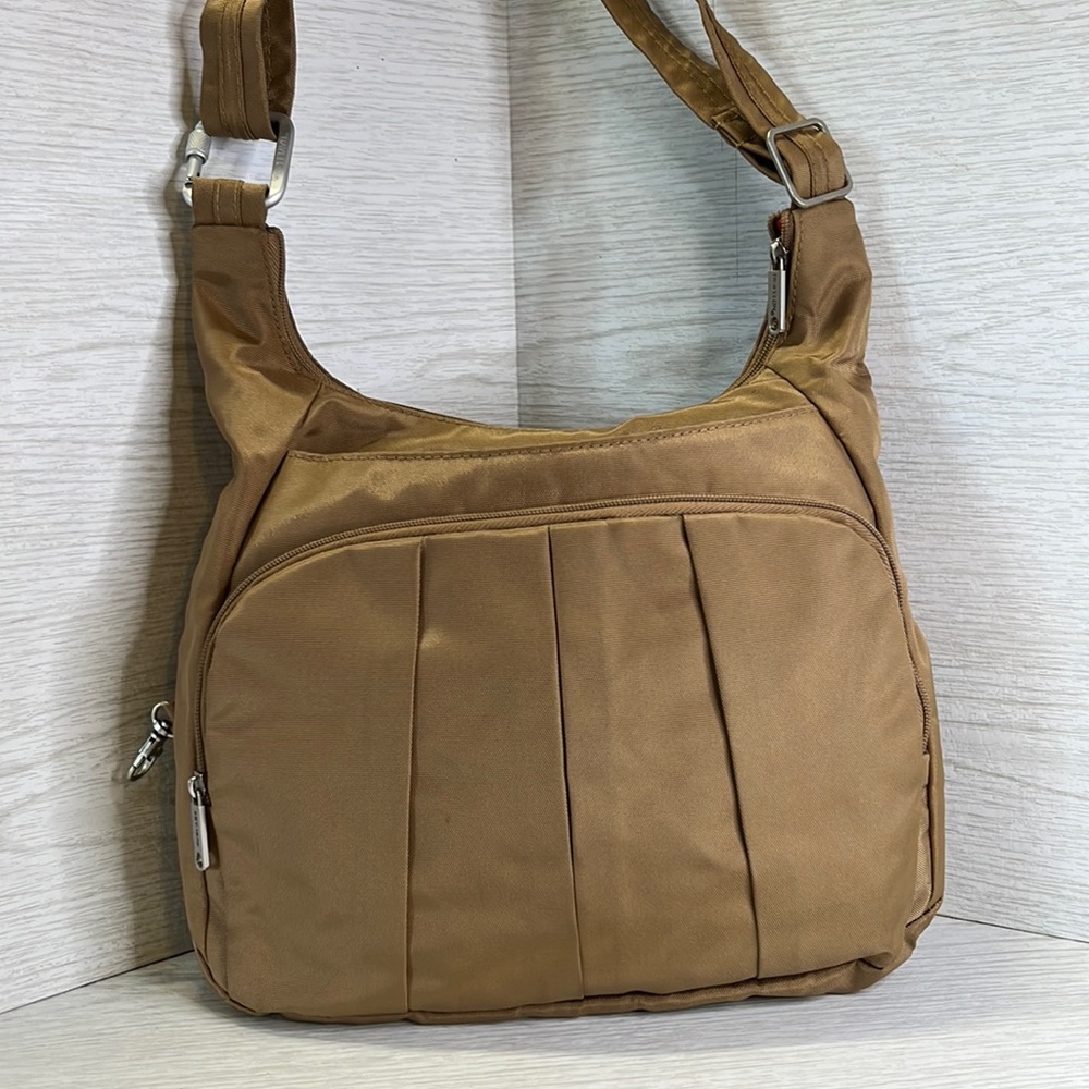 Travelon Nylon bag with adjustable strap and orange interior. A travel must have